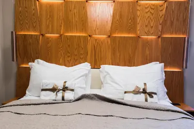 a bed with two white pillows with bows on them at Unicum Vite in Rome