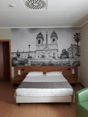 a bedroom with a bed with a mural of a church at Ele Green Park Hotel Pamphili in Rome