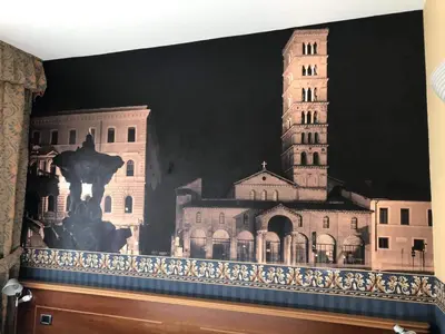 a mural of a building with a clock tower at Ele Green Park Hotel Pamphili in Rome