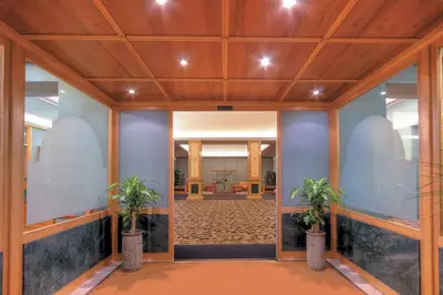an open hallway with two potted plants in a building at Ele Green Park Hotel Pamphili in Rome