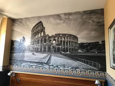 a mural of the coliseum on a wall at Ele Green Park Hotel Pamphili in Rome