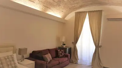 a living room with a couch and a window at Campani Luxury Flat in Rome