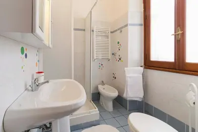 a white bathroom with a sink and a toilet at Albachiara Guest House in Rome