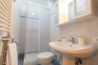 a bathroom with a sink and a toilet and a shower at Albachiara Guest House in Rome