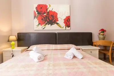 a bedroom with a bed with white towels on it at Albachiara Guest House in Rome