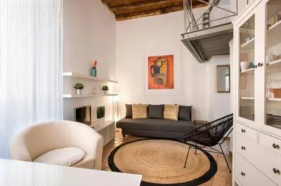 a living room with a couch and a chair at Imperial Loft in Rome