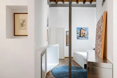 a room with white walls and a blue rug at Imperial Loft in Rome