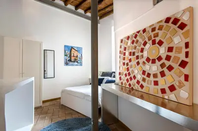 a bedroom with a bed and a painting on the wall at Imperial Loft in Rome