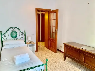 a bedroom with a bed and a table and a door at DaliTourism - Vatican Apartment 9 in Rome