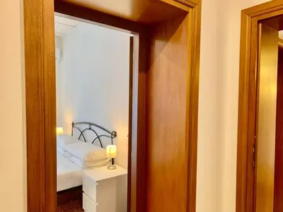 a small bedroom with a bed and a mirror at DaliTourism - Vatican Apartment 9 in Rome