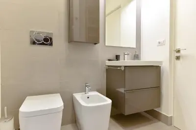 a bathroom with a white toilet and a sink at iFlat Via Veneto Design Studio in Rome