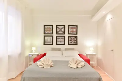 a bedroom with a bed with two towels on it at iFlat Via Veneto Design Studio in Rome