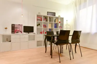 a dining room with a table and black chairs at iFlat Via Veneto Design Studio in Rome