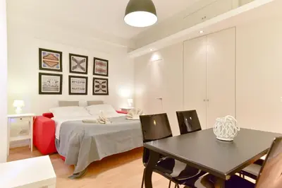 a bedroom with a bed and a table and chairs at iFlat Via Veneto Design Studio in Rome