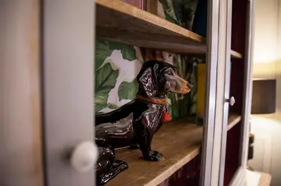 a dog figurine sitting on a shelf in a room at Casa Fabbrini Fancy Suites in Rome