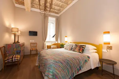 a bedroom with a bed and a table and chairs at Casa Fabbrini Fancy Suites in Rome