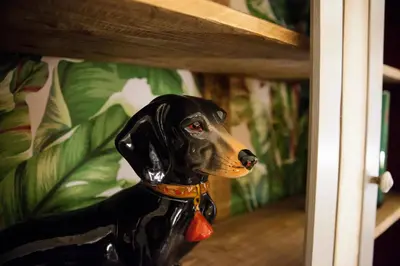 a black and brown dog figurine in front of a door at Casa Fabbrini Fancy Suites in Rome