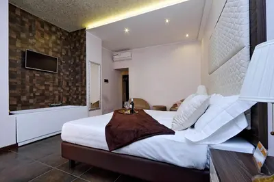 a bedroom with a large bed and a television at Roma Suite Monti in Rome