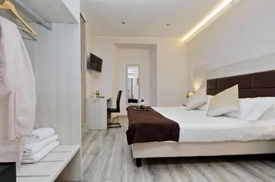 a bedroom with a large bed and a bathroom at Roma Suite Monti in Rome