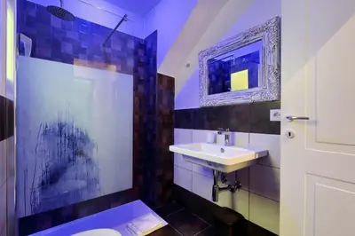 a bathroom with a sink and a toilet and a mirror at Roma Suite Monti in Rome
