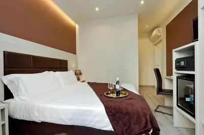 a hotel room with a bed with a table and a tv at Roma Suite Monti in Rome