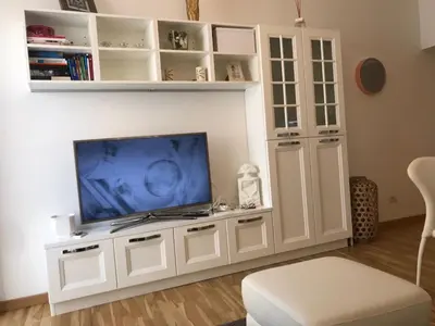 a white entertainment center with a flat screen tv at Rome dreaming house in Rome