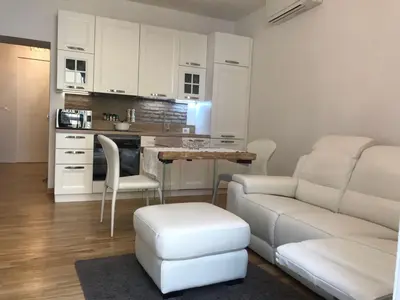 a living room with a couch and a table and a kitchen at Rome dreaming house in Rome