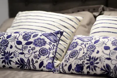 three blue and white pillows sitting on a couch at Home Alex in Rome