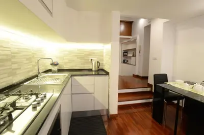 a kitchen with a sink and a stove at Home Alex in Rome