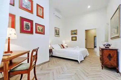 a bedroom with a bed and a table and a desk at Sistina 2 in Rome