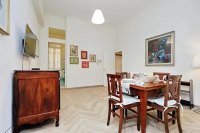 a dining room with a wooden table and chairs at Sistina 2 in Rome