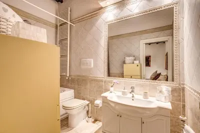 a bathroom with a sink and a toilet and a mirror at FRESH HOUSE TREVI 1 in Rome