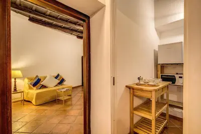 a living room with a table and a couch at FRESH HOUSE TREVI 1 in Rome