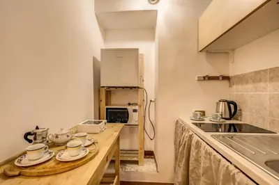 a kitchen with a counter with cups and plates on it at FRESH HOUSE TREVI 1 in Rome