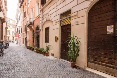 a cobblestone street with plants on the side of a building at FRESH HOUSE TREVI 1 in Rome