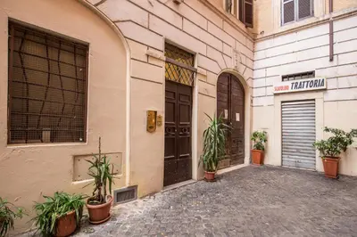 a building with doors and potted plants on a street at FRESH HOUSE TREVI 1 in Rome