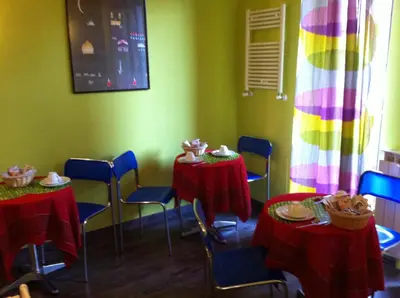 a room with two tables and chairs and a rainbow curtain at Almi Rooms in Rome