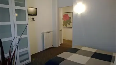 a room with a bed and a light on a wall at Almi Rooms in Rome
