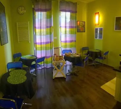 a room with tables and chairs in a room at Almi Rooms in Rome