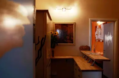 a room with a wooden table and a refrigerator at Art And Relax Suites in Rome