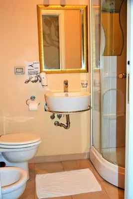 a bathroom with a sink and a toilet and a shower at Art And Relax Suites in Rome