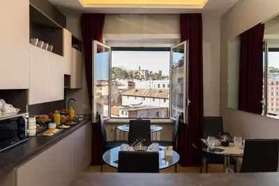 a kitchen with a table and a window with a view at Top Floor Trastevere in Rome