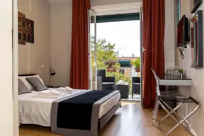 a bedroom with a bed and a sliding glass door at Top Floor Trastevere in Rome