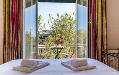 a bedroom with a bed and a large glass window at Top Floor Trastevere in Rome
