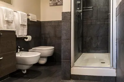 a bathroom with a toilet and a sink and a shower at Top Floor Trastevere in Rome