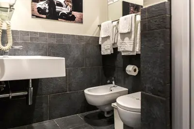 a bathroom with a white sink and a toilet at Top Floor Trastevere in Rome