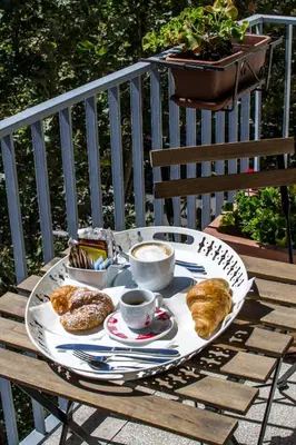 a tray of food on a table with coffee and croissants at Top Floor Trastevere in Rome