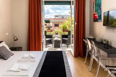 a room with a bed and a view of a balcony at Top Floor Trastevere in Rome