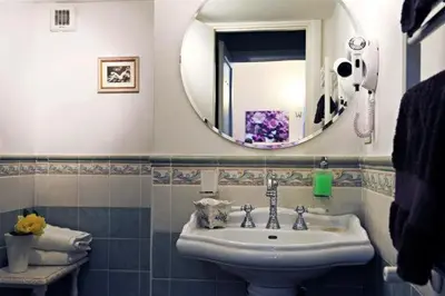 a bathroom with a sink and a mirror at B&B Alexander in Rome
