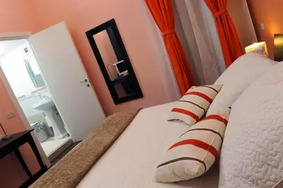 a bedroom with a bed with a mirror and a sink at B&B Alexander in Rome